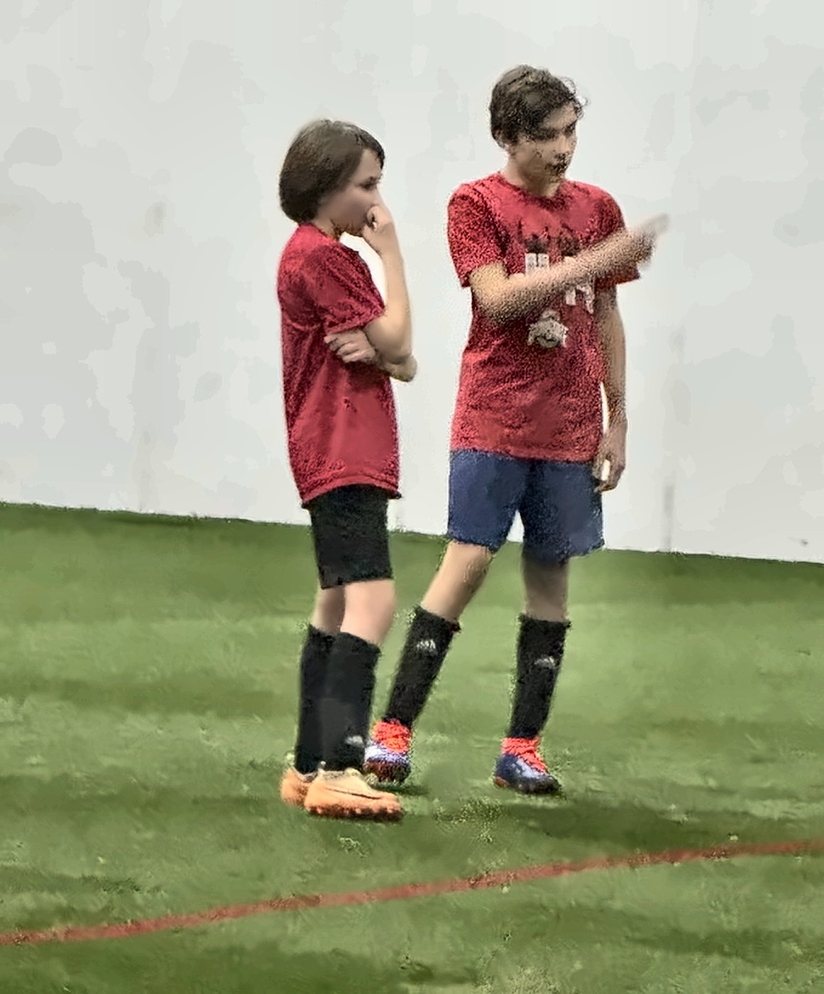 Jackson explaining a move to a younger player on indoor turf
